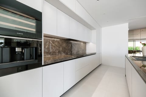 A fully equipped kitchen (microwave oven, espresso machine, wine fridge, toaster, kettle...), kitchen island with 4 bars chairs and a wooden dining table