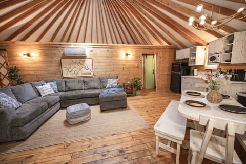 Such a cozy space with beautiful wood and natural light from the Yurt design.