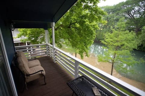 The shaded balcony offers a front-row seat to the river without the midday heat. It is the go-to spot for a glass of wine and good conversation while the breeze rolls off the water.