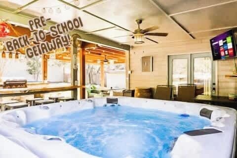 Unwind in your private 6-person hot tub under a covered patio with ceiling fans, string lights, and plenty of seating. Ideal for relaxing nights after exploring local attractions like Son’s Island or Whitewater Amphitheater.