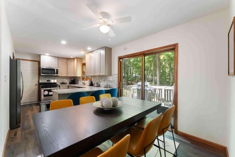 Open dining space that flows from the kitchen to the deck — ideal for entertaining. - The Pasquin - East Stroudsburg, PA