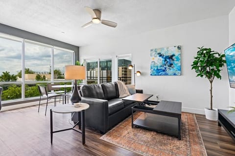 Beautifully designed living room. 65` TV, leather sofa and amazing views of mountains and city skyline.