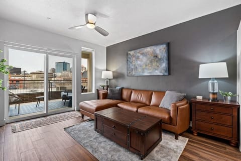 Relax and rechargeBeautifully designed living room. 75` TV, leather sofa and amazing views of mountains and city skyline. in this highly-designed space featuring a luxury couch and local art!