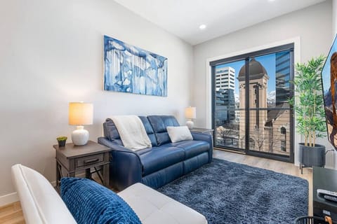 Gorgeous Livingroom, 65` TV, Comfy  colorful leather couch.