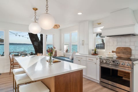 This stunning lakeview kitchen is a chef’s dream and the heart of the home — featuring a 36" professional stove, a spacious 7' island for gathering, and a fully stocked coffee bar. Settle into the window seat to savor the view, or catch today's big game.