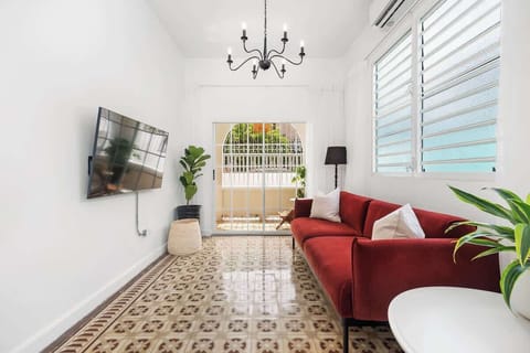 The living room offers a perfect blend of comfort, entertainment, and access to the private balcony