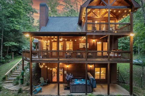 The wraparound porch offers breathtaking views of the surrounding forest.