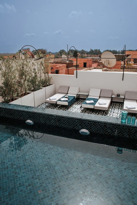 Outdoor pool, open 10:00 AM to 8:00 PM, pool umbrellas