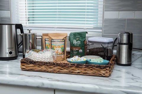 Our newly renovated kitchen is outfitted with sleek stainless steel appliances and fully stocked with plenty of cups, dishes, and a variety of pots and pans for cooking. A dedicated coffee station provides everything you need for your morning brew.