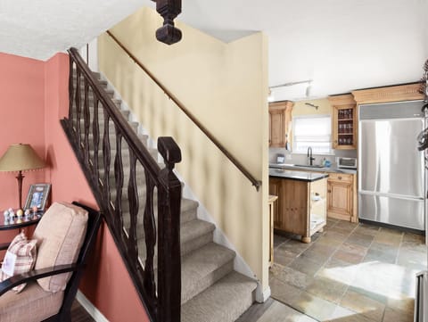 The view from the living towards the kitchen and the stairs leading to the third floor.
