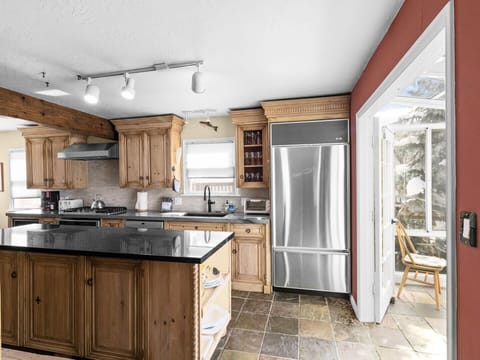 The fully equipped features stainless steel appliances, a large kitchen island, and all the cookware you need to whip up a delicious meal.