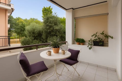 Peaceful Balcony Retreat with Lush Green Views, Plum Cushions, and Morning Coffee Setup

