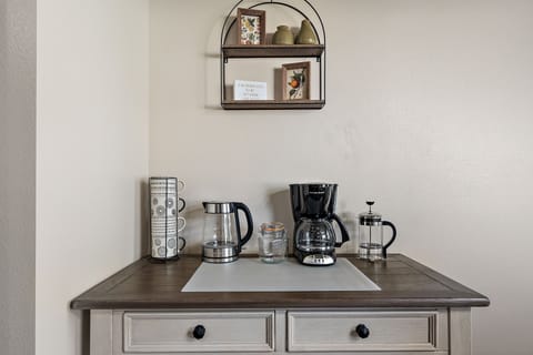 Coffee bar stocked with coffee, creamer and sugar. 