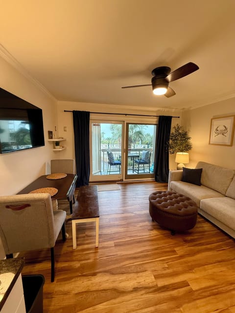 Main living space.  Sleeper sofa.  Dining table and access to patio
