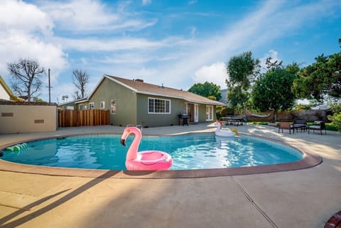 Spacious and well maintained backyard with salt water pool, bbq grill, outdoor games, large green space, and outdoor seating. Enter into your own private oasis.
