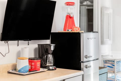 A coffee pot, fridge and frozen drink mixer convenient for entertaining by the pool