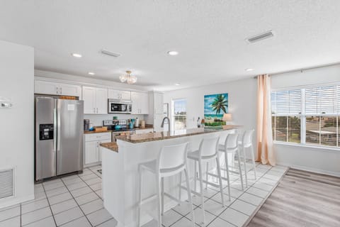 Bar stool seating for 4 provides additional seating for dining.