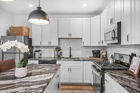 The stylish kitchen is equipped with stainless steel appliances and all the cookware, dishware, and utensils you need to cook delicious meals with friends or family during your stay.