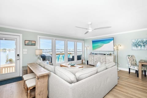 Relax in this bright living room with harbor views, comfy seating, and coastal charm.