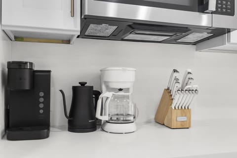 Kitchen with Keurig machine, hot water kettle, and drip coffee maker.