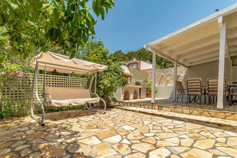 A shaded swing near the orange tree for your relaxation.