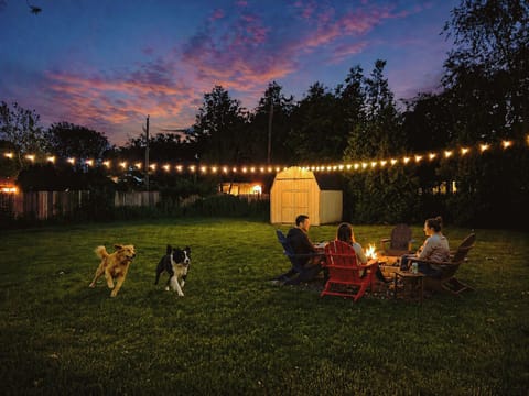 Enjoy fireside nights & a backyard made for everyone, pups included!