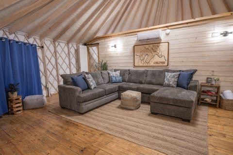 Such a cozy space with beautiful wood and natural light from the Yurt design.