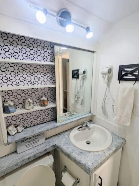 Bathroom is stocked with towels and toiletries 