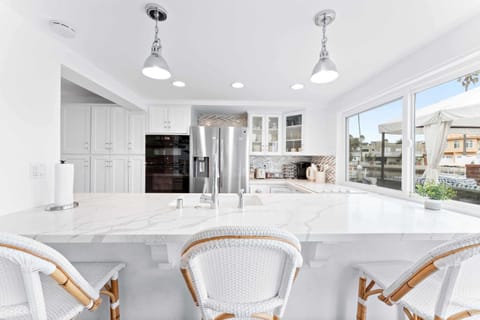 The large kitchen island comfortably sits 3 guests.