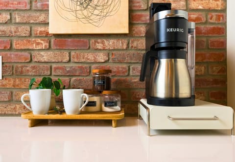 A well-appointed coffee station with all the essentials, perfect for preparing a quick meal or snack during your stay.