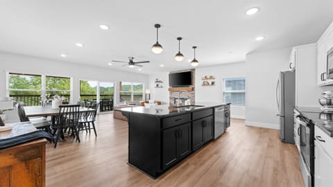 Fully stocked kitchen with huge island, dining for a crowd, and modern finishes.
