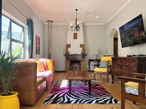 A comfortable lounge with TV connected to Netflix and wood burning fireplace. The house has a back up solar energy system keeping lights and some plugs on. Kitchen appliances not connected due to high consumption.