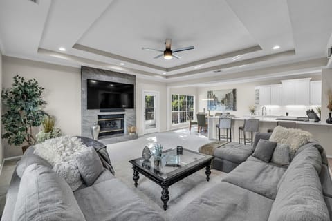 80` TV with Sound Bar/Sub Gas Fireplace Sectional Sofa Open to kitchen Coffee Table Ceiling Fan Alexa Access to back patio/yard