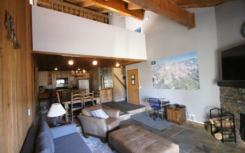 Spacious yet cozy living room, dining area, and kitchen form one great room. 