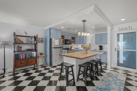 Full kitchen, with new appliances and a large island for storage and food prep.