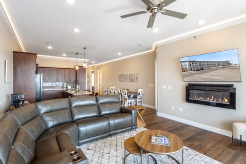 Watch TV with full theater sound on the flat screen over the elegant electric fireplace.