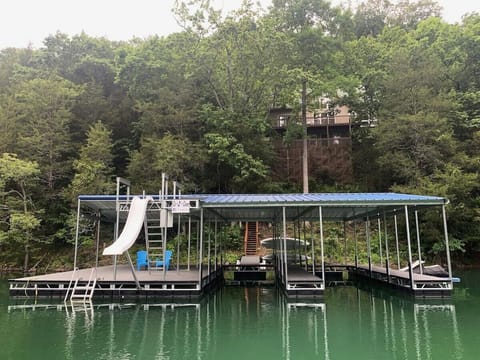Dock with jumping platform, slide, 2 covered slips, 2 jet ski ports.