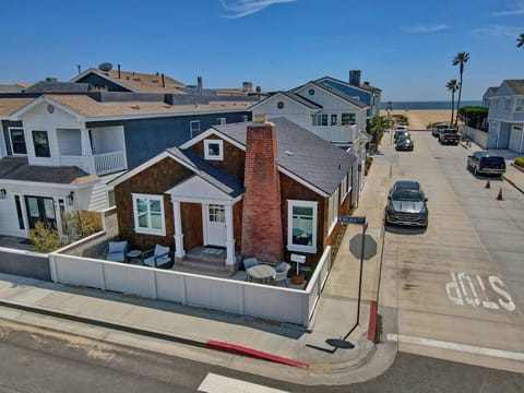 Your beautiful front patio includes a fire pit sitting area, and a bistro table.  You see that the beach house is very close to the sand.