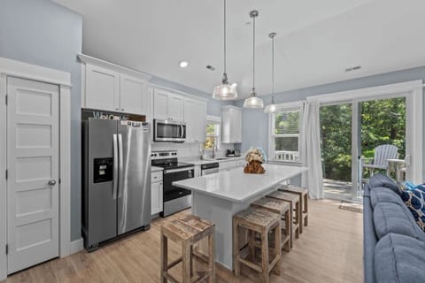 Bright open kitchen and living space with island seating and lots of natural light.