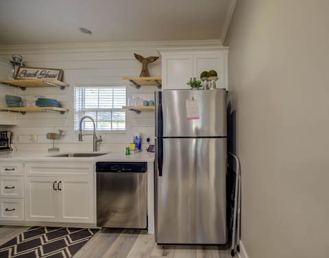 Well-equipped kitchen stocked with pots/pans/utensils.