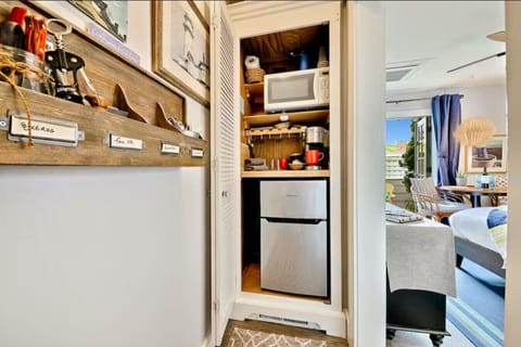 Kitchenette area with a mini fridge, microwave, and Keurig