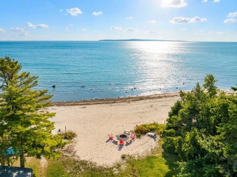 Aerial view of the beach and Mackinac Island in the distance.