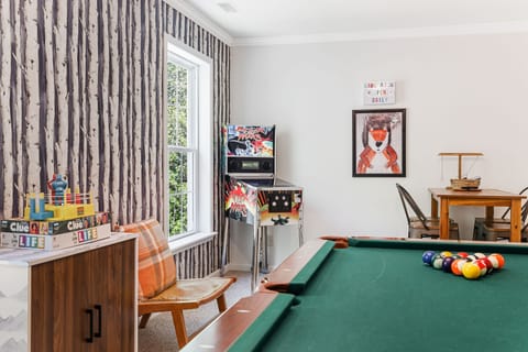 The game room including pool table, electronic pinball and Roku TV