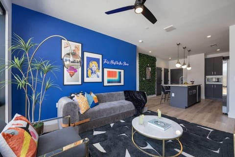 Bright open concept living area with floor to ceiling windows providing panoramic views of Midtown! Features designer furniture and smart TV!
