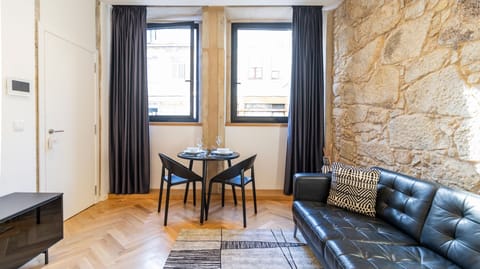 Our modern living room counts with a comfortable couch, a dining area and a flat screen TV #stunning #airbnb