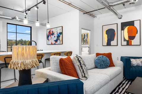 Gather in this inviting living space after a day of exploring, laughter echoing off the walls as the sun sets and the city lights begin to sparkle outside.