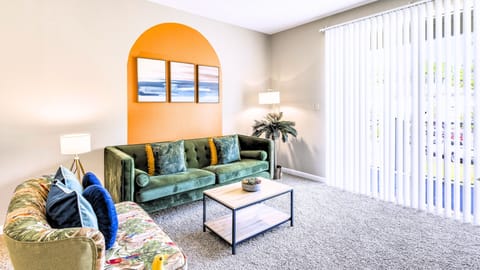 A cheerful living room with bold coastal color and comfy seating.
