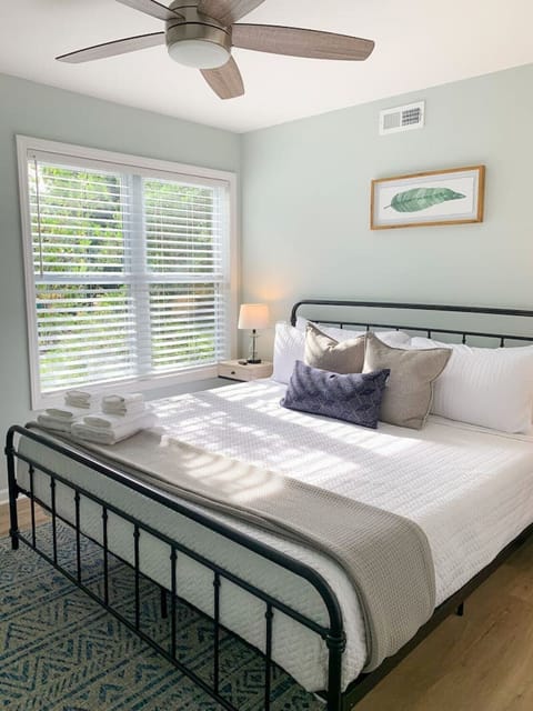 The King room is extra spacious and has a large window for evening light. Both nightstands have lamps and access to outlets for convenience.