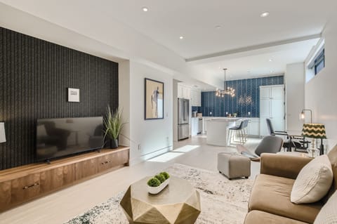 Large living room area with a tv and a separate queen sized sofa bed available.