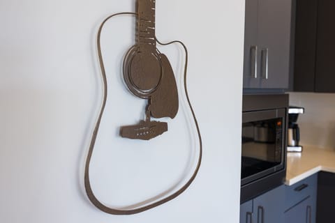 Fully equipped modern kitchen boasting brand-new stainless-steel appliances and stocked with all culinary essentials for ease and convenience. Kitchen island offers ample counter space and bar seating.